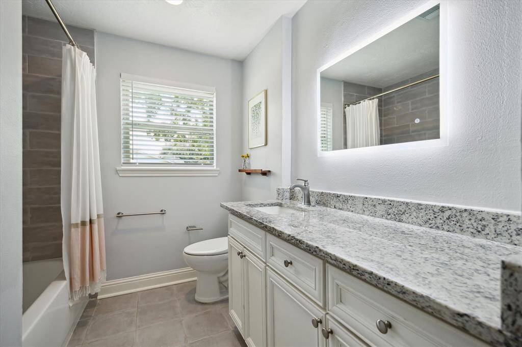 This bath off the bedroom wing hallway has tub/shower combo and serves the secondary bedrooms.