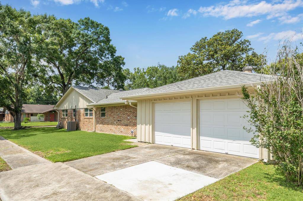 The garage is entered from the Braesmont side and offers a double wide driveway and additional parking.