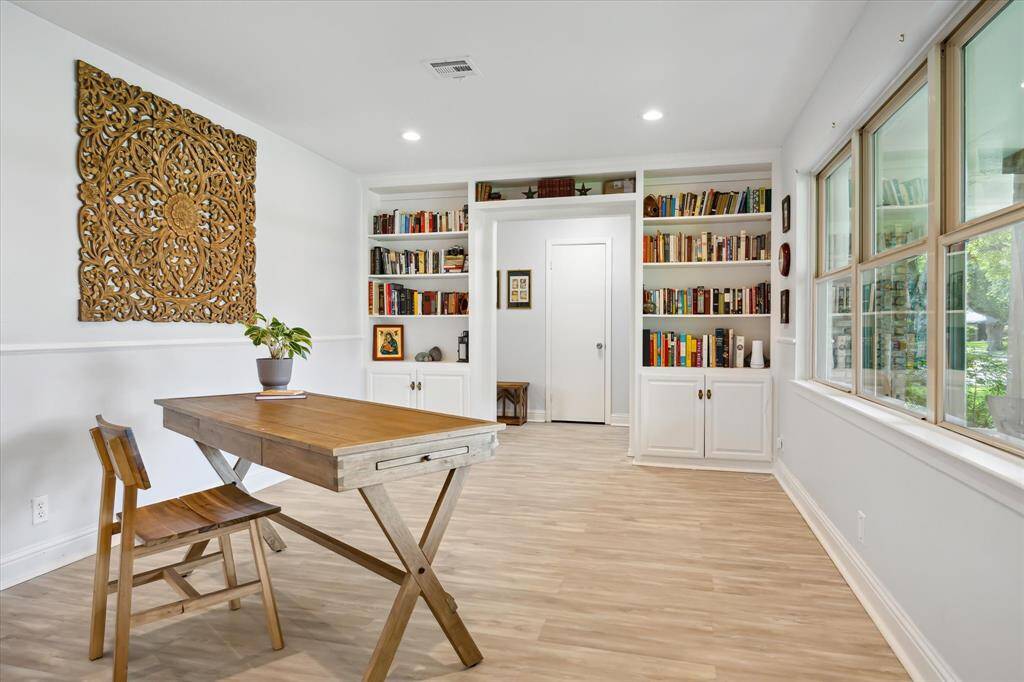 The front room, just left of the entry has large recessed can lighting, picture window looking onto front yard and built-in display shelving. Multi-purpose room may serve as living room, dining room, or home office.