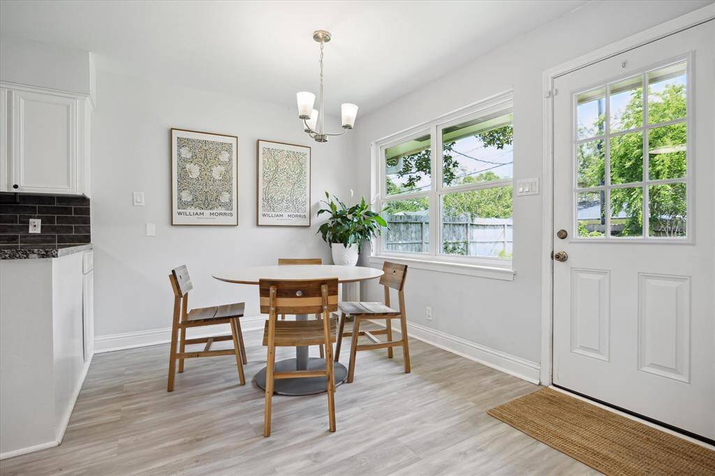 The sunlight filled breakfast room is at the juncture of the den and kitchen and has a handy exit to the back yard patio.