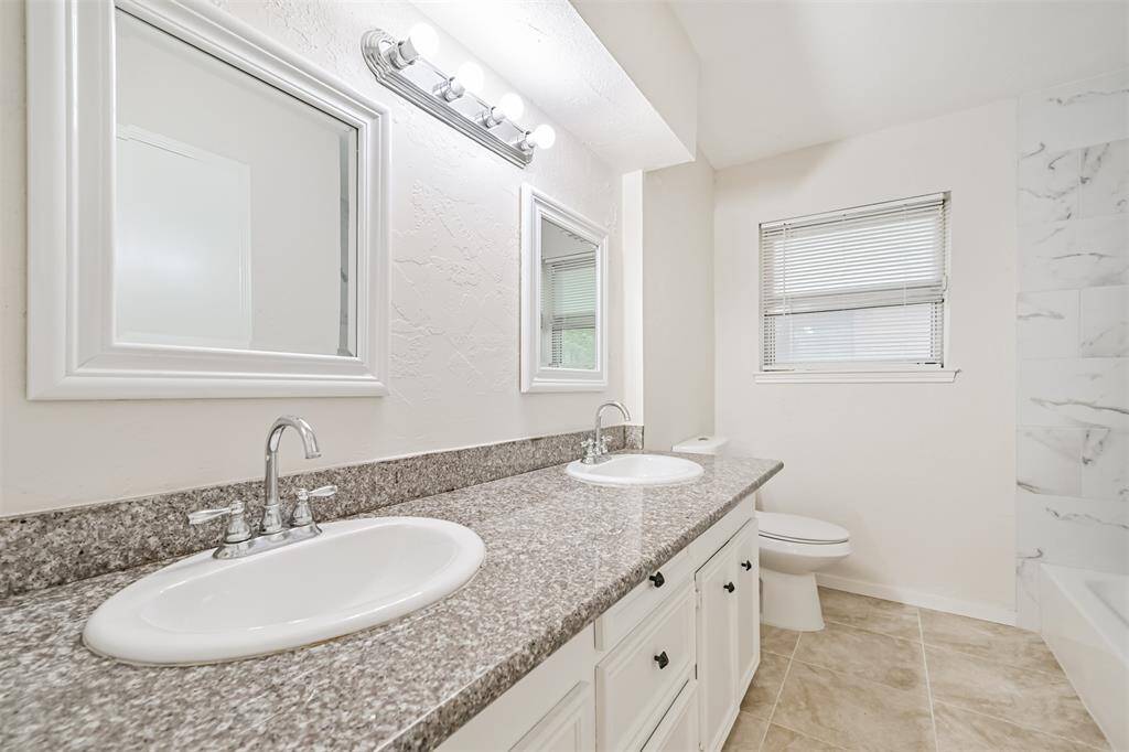 Hall bath has large vanity with dual sinks!