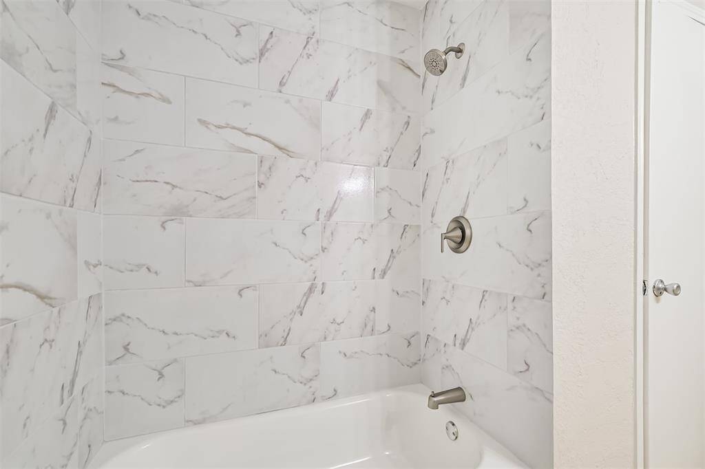 Hall bath has matching shower surround as the Primary bath
