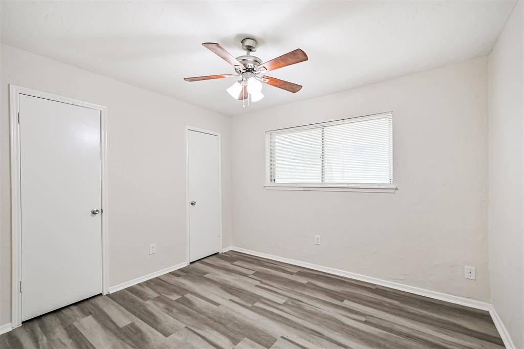 Bedroom 2 with vinyl plank flooring and ceiling fan