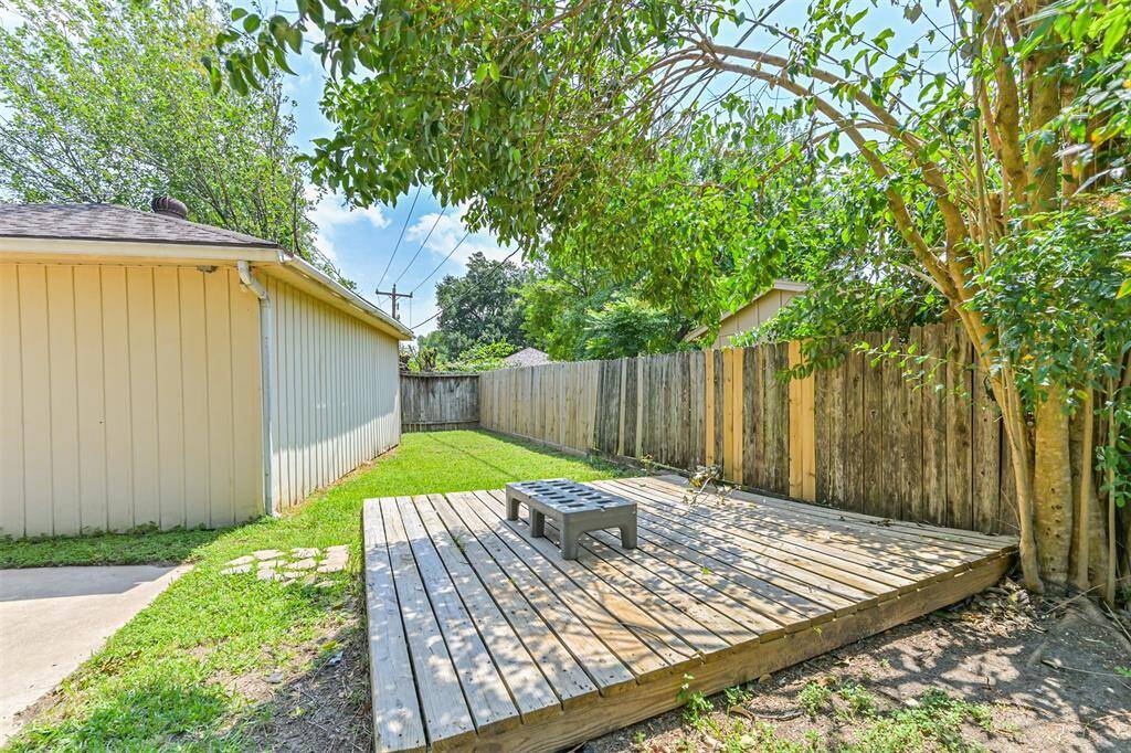 Backyard also has a wooden deck for your BBQ pit!