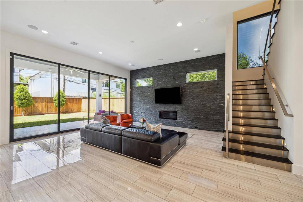 Living area with oversized sliding glass doors that fully open and lead to the covered patio & backyard.