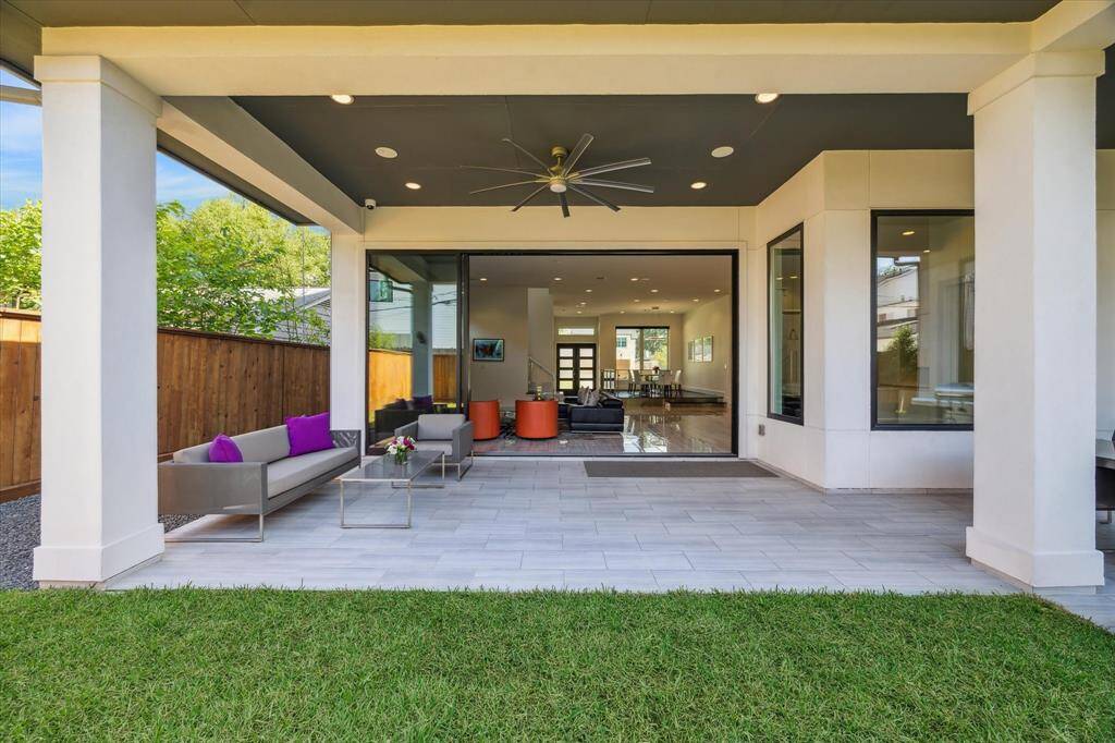 View of the covered patio with the sliding doors open.  Great for entertaining!  It is also surrounded by a mosquito misting system.