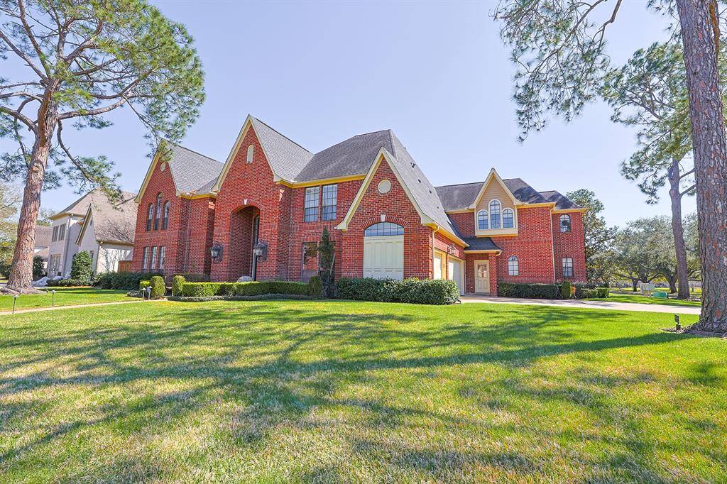 A grand brick facade with elegant architectural details welcomes you to this stunning home.