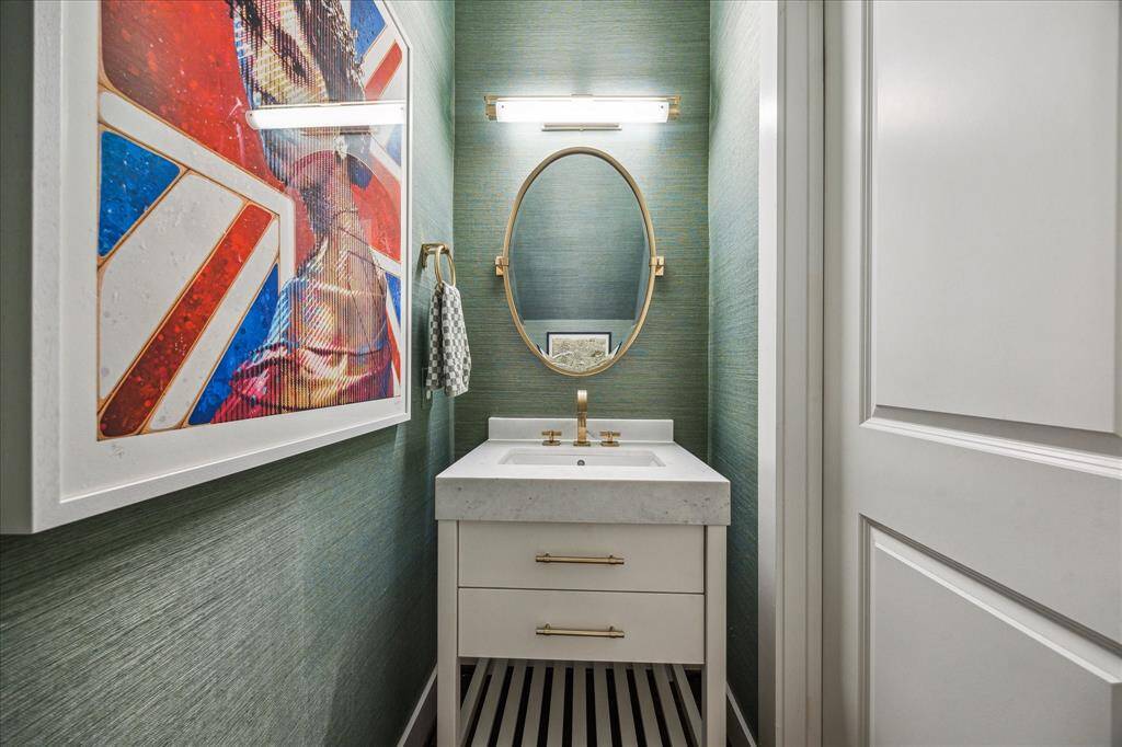A view of the first floor powder bath beautifully decorated with Grasscloth wallpaper.