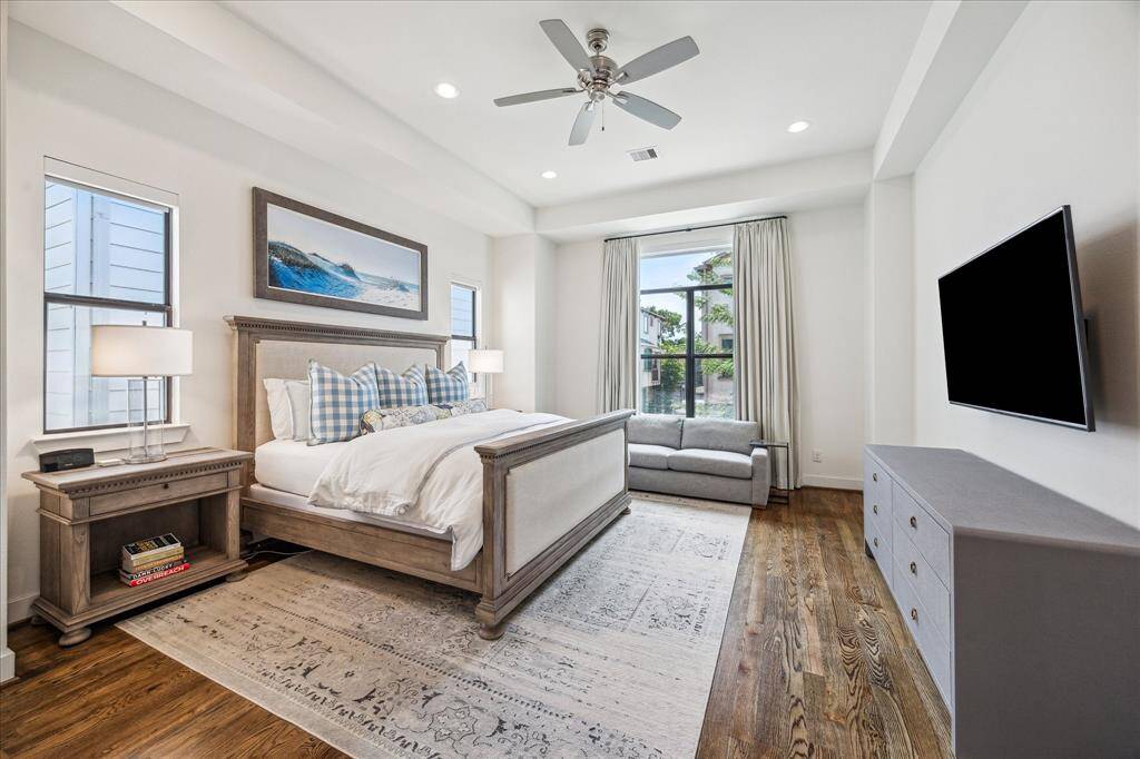 The large primary bedroom is beautiful with ample natural light and stunning raised ceilings.