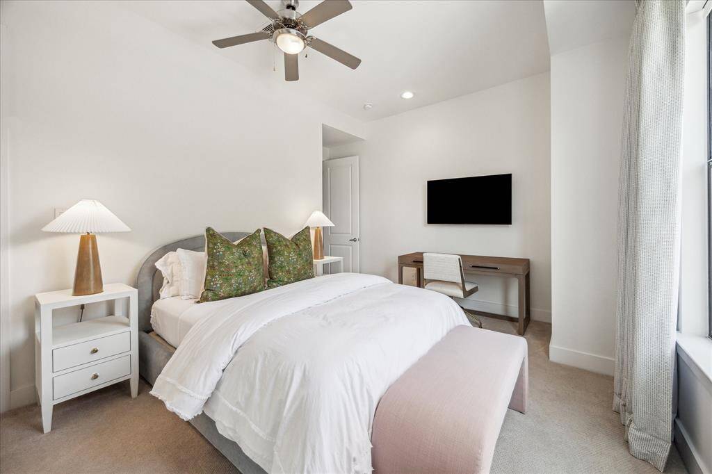 The third bedroom with a beautiful window looking out to the street.