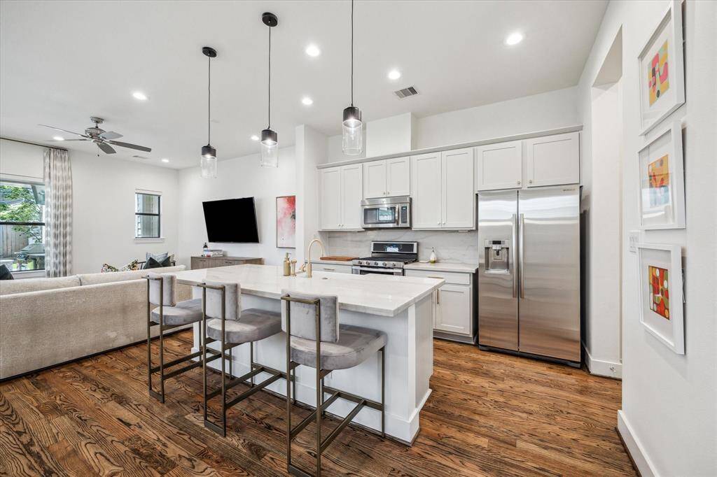 An open concept kitchen was recently remodeled with Marian Louise Designs with quartzite countertops and backsplash.  The dishwasher was replaced in 2024.
