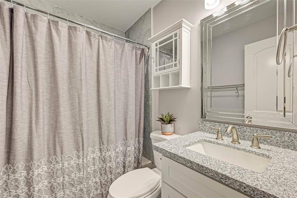 The bathroom to the secondary bedrooms features a tub and shower combo with tile surround, beautifulcounter tops, and white cabinets!