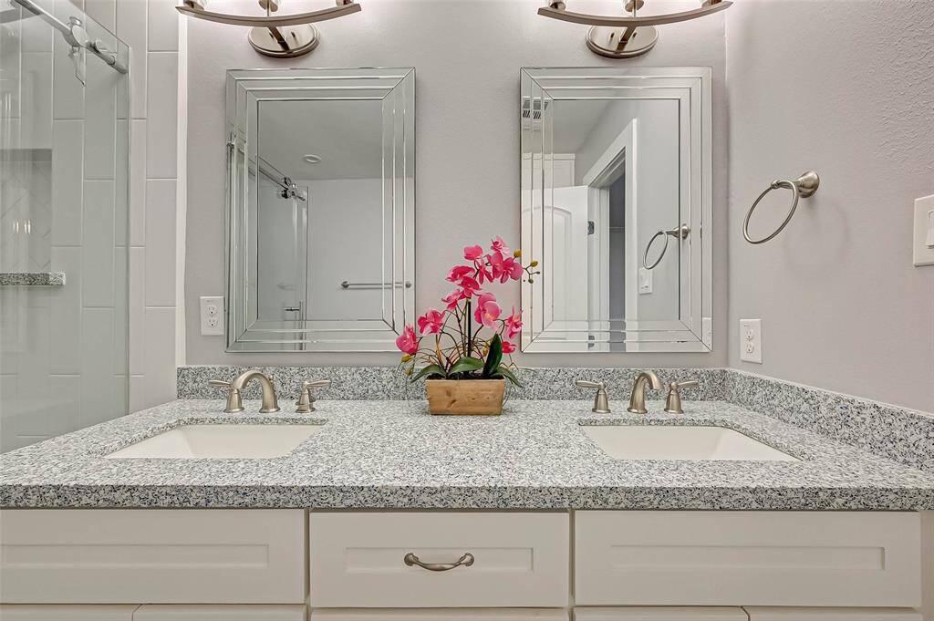 Another view of the primary bathroom dual vanity sinks with dual mirrors.