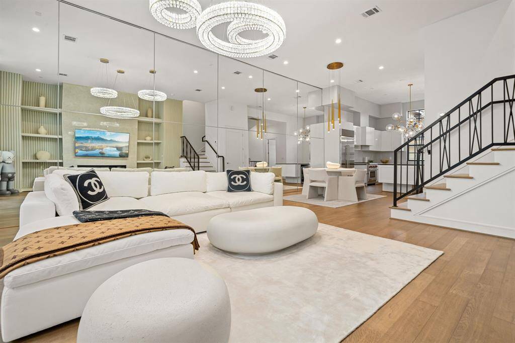 Open floor plan with a sleek, white kitchen, elegant dining space, and a cozy lounge area!