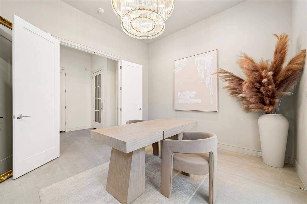A large, modern chandelier adds sophistication to this first-floor bedroom currently being used as an office!