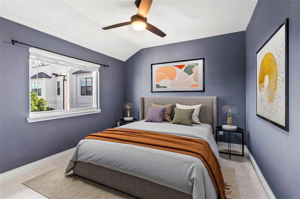 Step into your inviting secondary bedroom, where a large window bathes the space in natural light, enhancing the rich blue walls and plush carpeting. The room exudes a calm, modern ambiance, with a sleek ceiling fan for added comfort. Clean lines and neutral finishes provide a versatile backdrop—perfect for a cozy bedroom, inspiring office, or creative retreat.