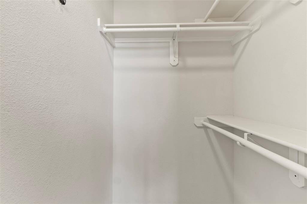 Double hanging rods and overhead shelving help maximize your closet space, making it easy to keep things tidy and accessible.