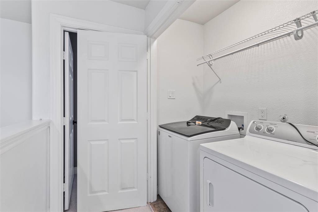 Tucked just off the hallway, your laundry area keeps daily chores convenient and out of sight. With built-in shelving for storage and space for a full-size washer and dryer, it’s a practical spot that blends seamlessly into the flow of the home.