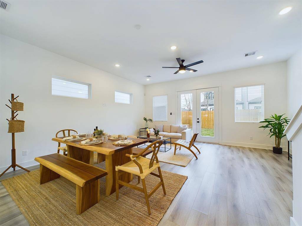 open concept living/dining/kitchen area on the first floor including Bifold Doors to walk out into backyard.