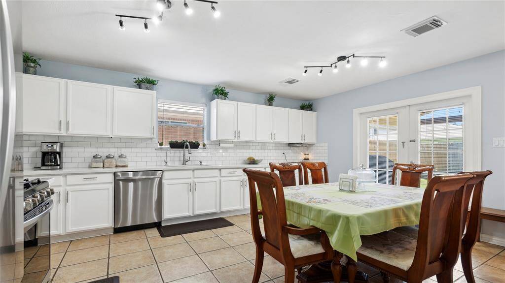 Beautiful white cabinets with nice back splash.