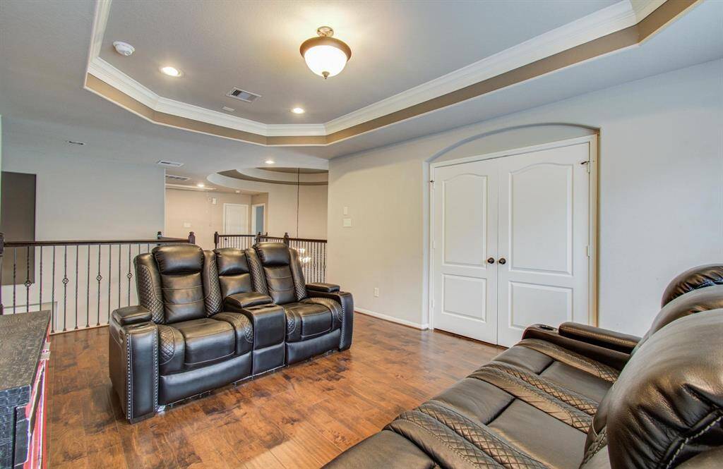 Enjoy seamless entertainment flow with this inviting view from the game room into the cozy media room.
