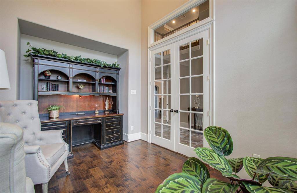 This photo showcases a cozy home office with elegant wood flooring.