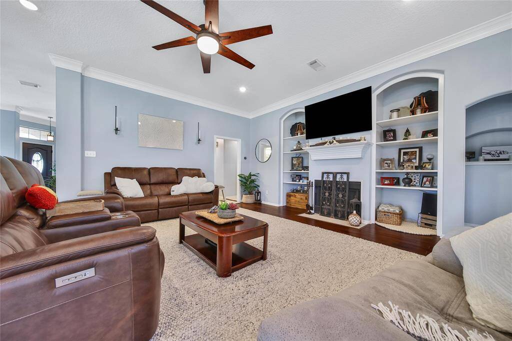 From the family room top left hallway, the laundry room, bath and secondary bedrooms can be found in this split plan.  The primary suite is located just to the right over looking the backyard green space.