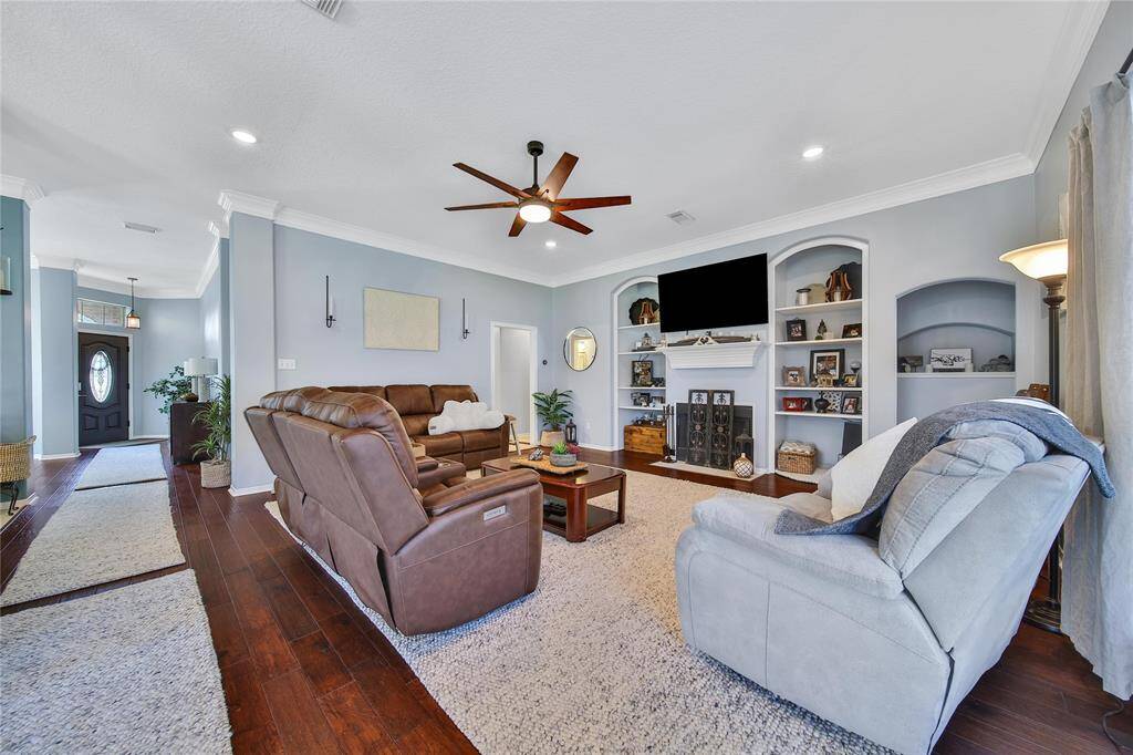 Meticulously maintained, the family room in this home offers updated flooring, updated fan, custom built in shelving and a gas fireplace.