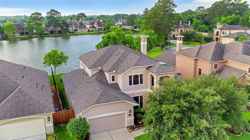Charming two-story home with a spacious driveway, nestled in a picturesque lakefront setting. Features a well-maintained exterior, lush landscaping , and stunning water views. Ideal for serene living.