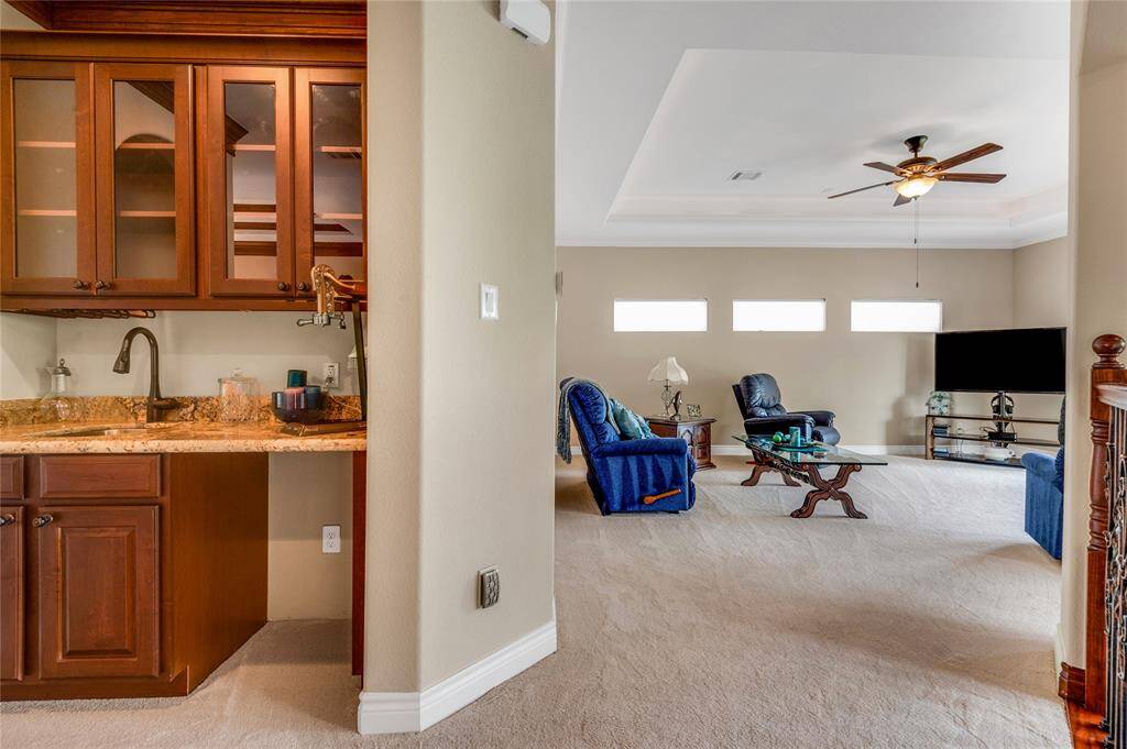 The upstairs game room is adjacent to a wet bar.