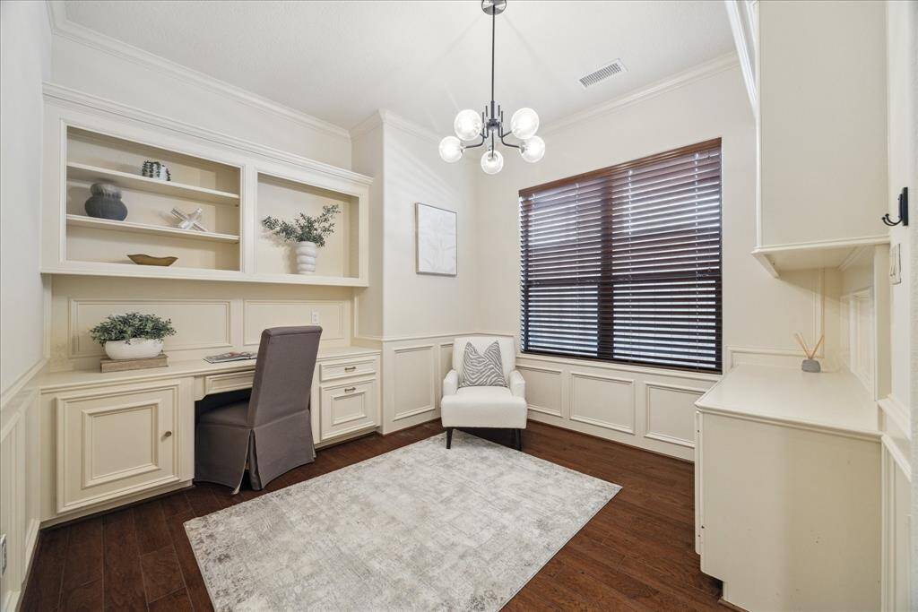 Large office is located on the 1st floor, complete with built-ins on both sides of the room.