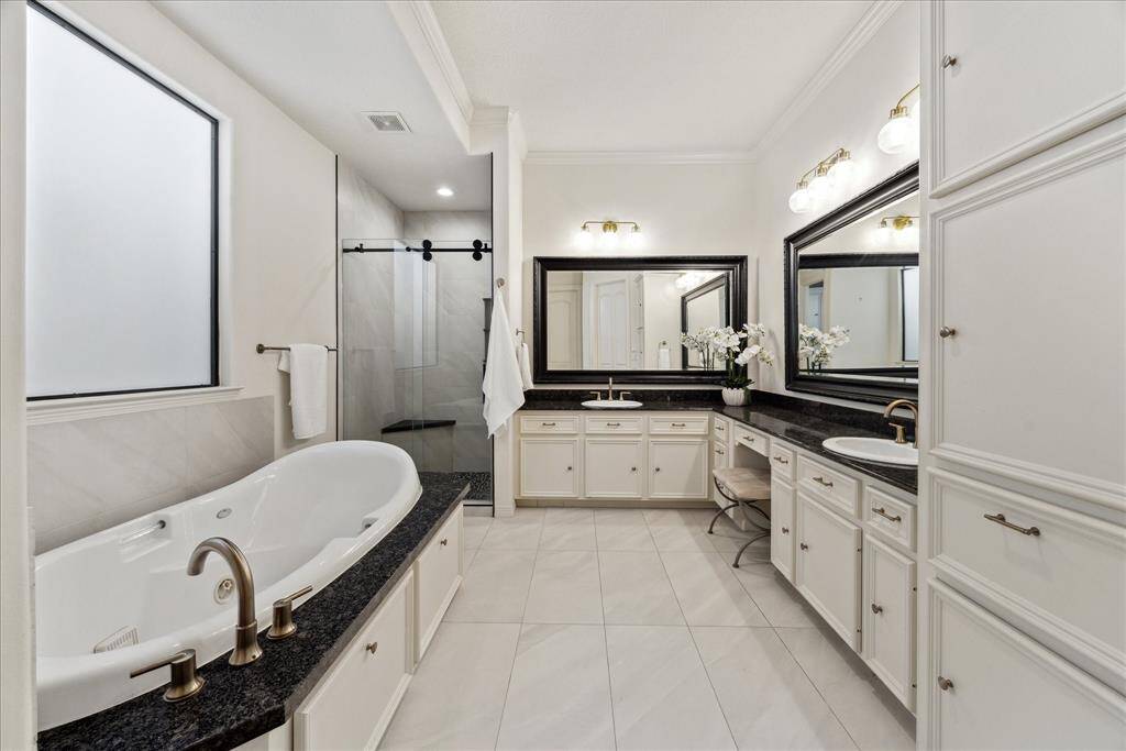 En-suite primary bath with large vanity, double sinks, soaking tub, separate shower and water closet.