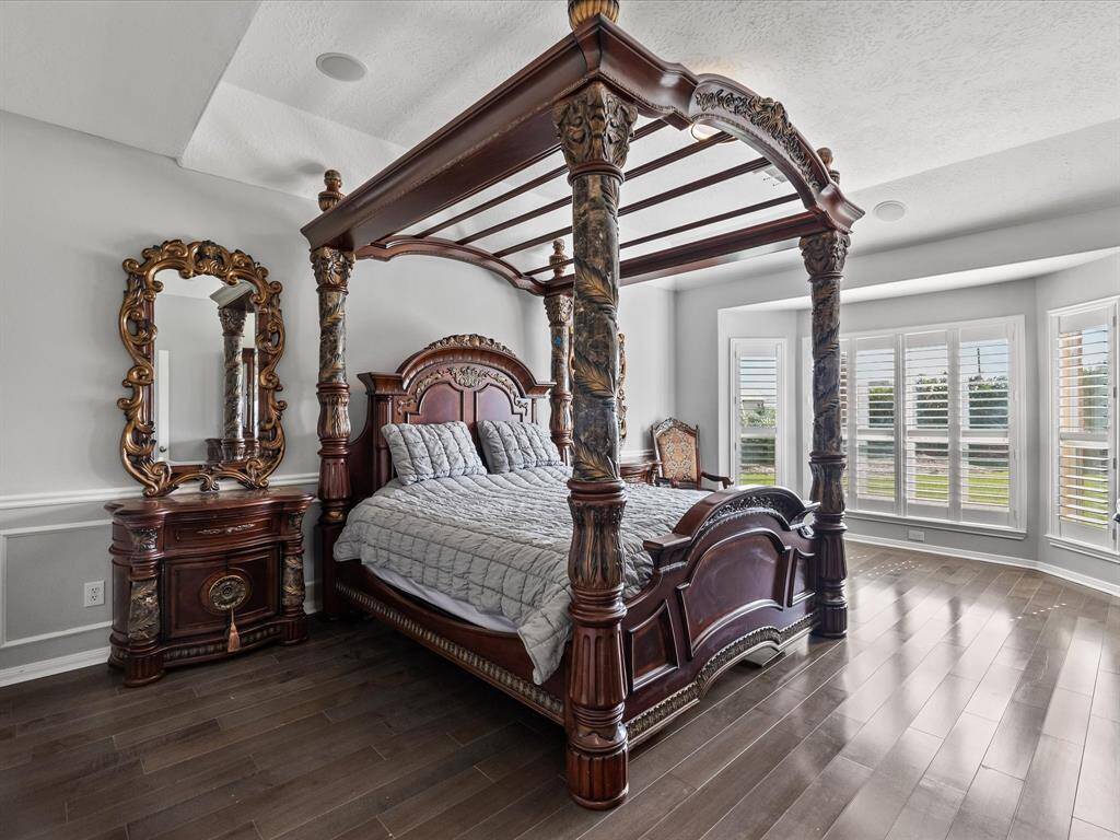 Spacious owners suite with high ceilings and bay window that overlooks back yard.