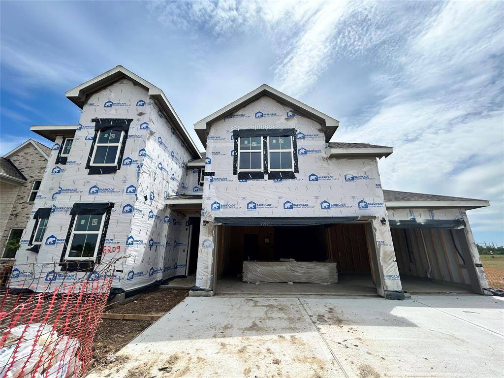 Two story home with 5 bedrooms, 4.5 baths, and 4 car garage.