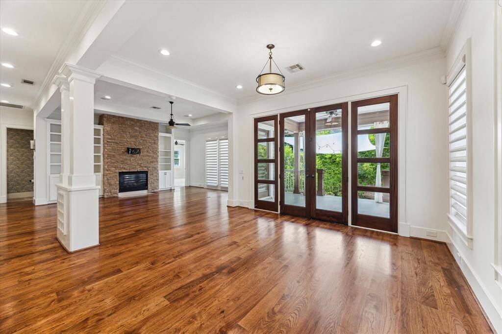 The living room centers around a cozy fireplace, flanked by built-in shelving for charm and function.