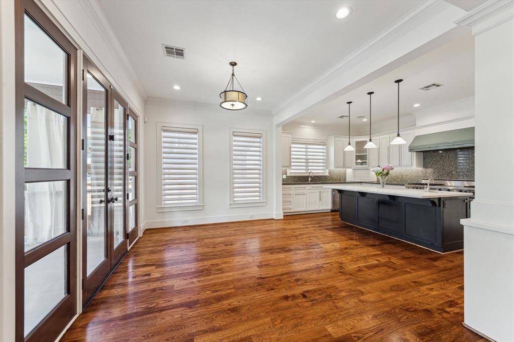 The gourmet kitchen features premium Viking appliances, an island with a prep sink, and a built-in wine refrigerator.