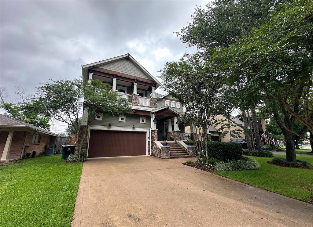 Picturesque side view of the home framed by mature trees, providing beauty and privacy.