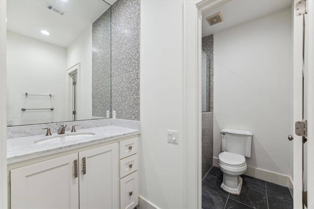 Well-appointed ensuite bathroom with modern finishes and ample storage.