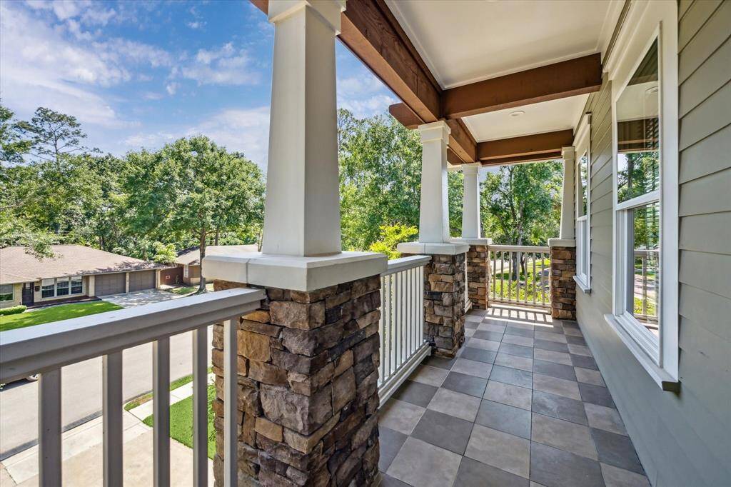 Covered backyard patio offers a serene space for outdoor dining or lounging.