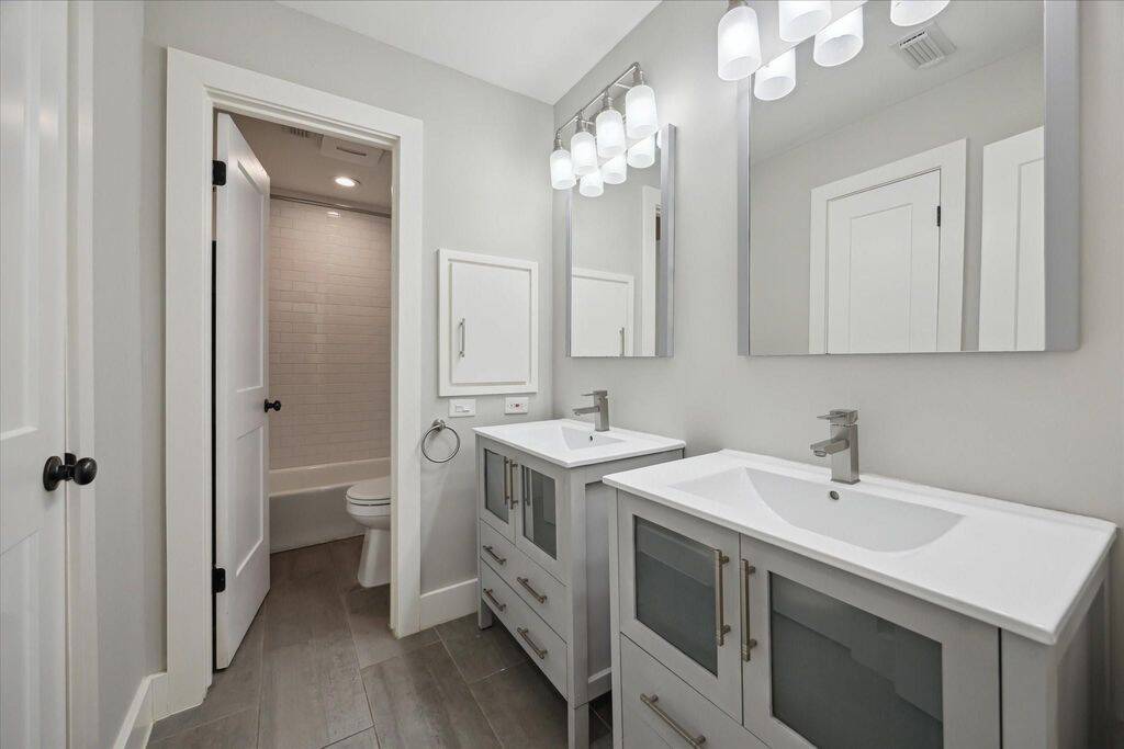 The secondary Hollywood bathroom is accessible from the hallway, providing a functional layout that allows multiple people to get ready with ease—without disrupting one another’s morning routine.