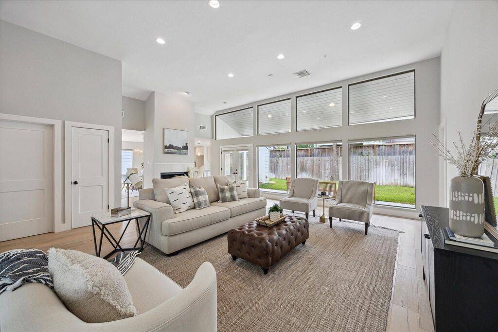 ..and back yard. Framed by large windows, the living room feels light, airy, and effortlessly welcoming—an ideal space to exhale and unwind.