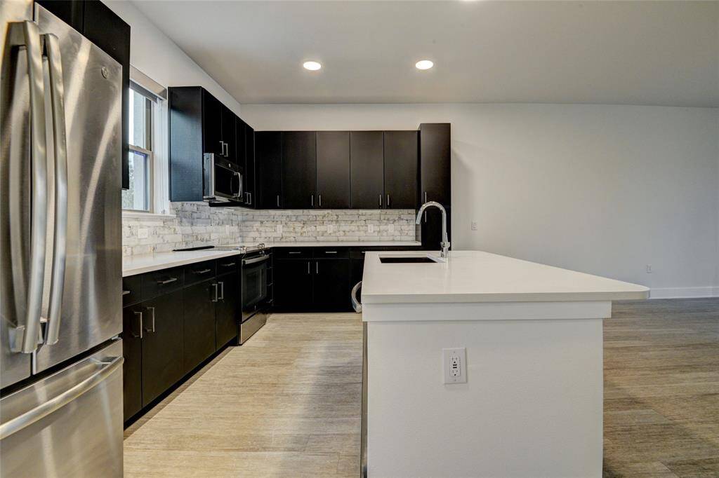 The kitchen features abundant cabinetry and counter space.