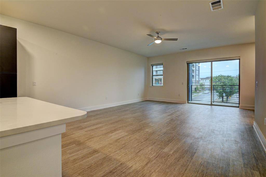 The view from the kitchen overlooks the living room and the balcony.