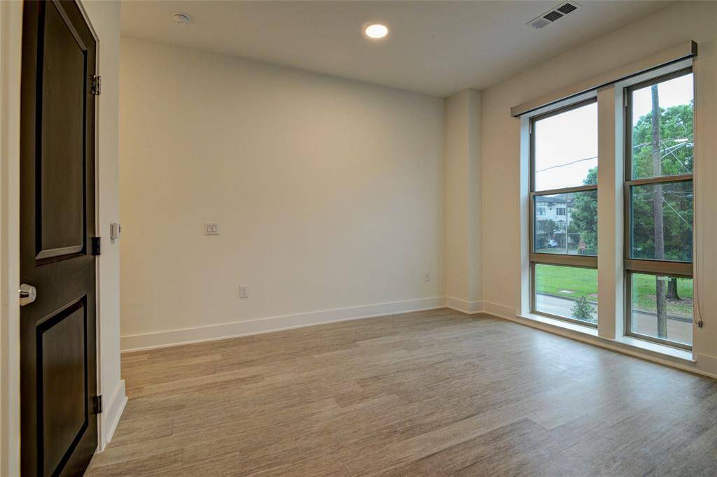 This room can serve as either a dining room or a study/den area.