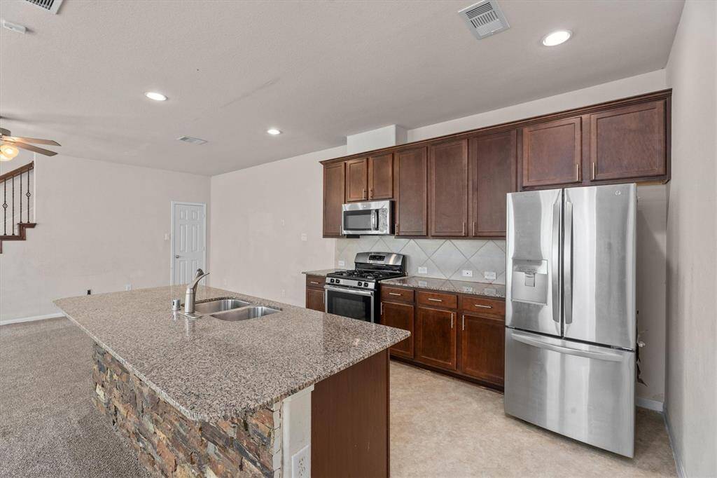 The heart of the home! Love the island and beautiful granite countertops.