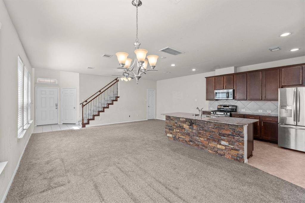 Another view - the kitchen has 42 inch Mocha cabinets.  Check out the beautiful stair case railing.