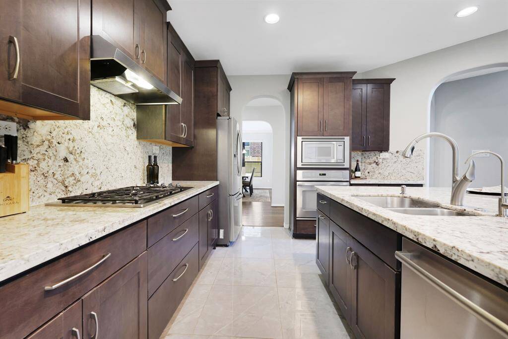 Welcome to your gourmet kitchen with Wolf cabinets, stainless steel appliances, gas cooktop and STUNNING granite countertops.