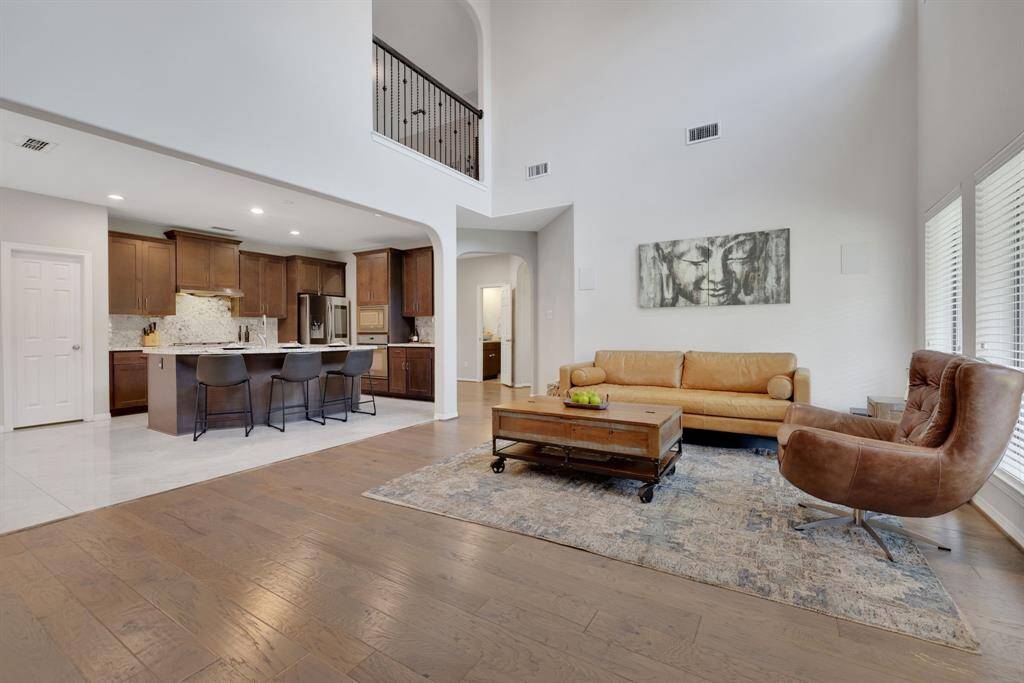 Open concept kitchen with two story living area showcasing an overlook from the second floor game room!