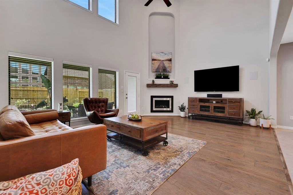 Stylish gas fireplace with large wood mantle serves as the focal point for this spacious living room
