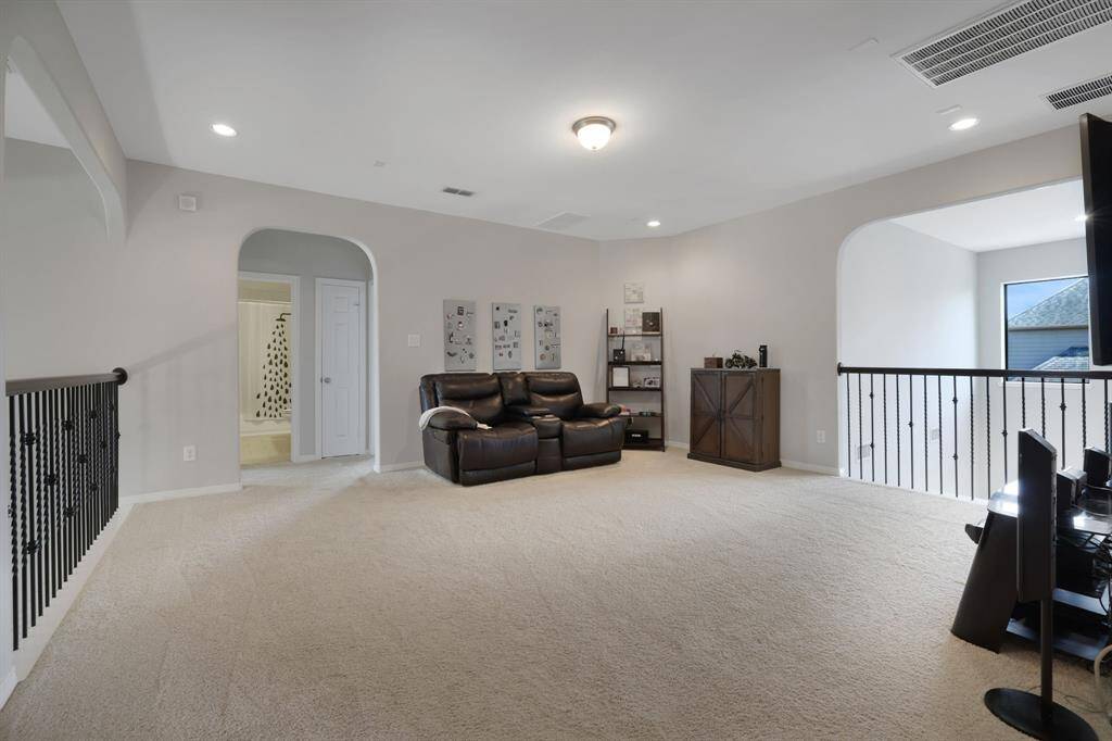 Generously sized game room at the center of the second level with overlooks to both the kitchen and front entryway.
